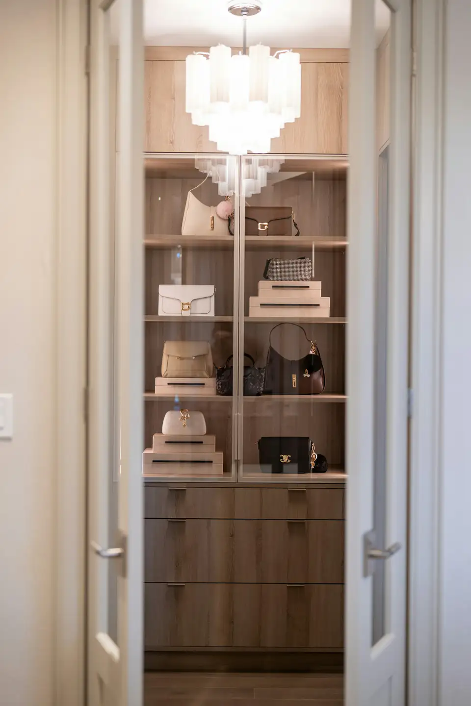 Glass-fronted display wardrobe | Fitted wardrobes Newcastle Glass-fronted display shelving holding handbags on oak-effect shelves, design inspiration for bedrooms in Newcastle