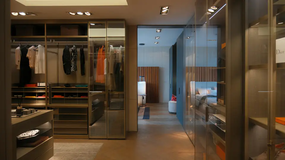 Glass-walled walk-in wardrobe suite with hanging space and drawers, a fitted wardrobe idea for Newcastle homes