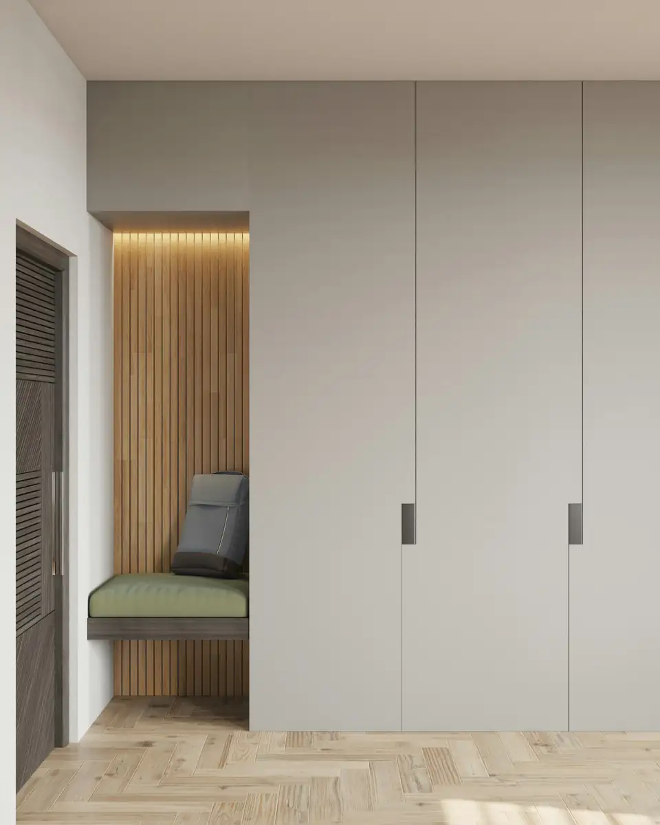 Grey handleless full-height wardrobe beside a slatted oak panel and upholstered bench, a storage idea for homes in Newcastle