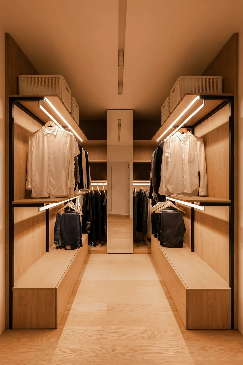 Walnut walk-in wardrobe with lighting | Fitted wardrobes Newcastle Walnut-toned walk-in wardrobe with warm LED lighting above the hanging rails, design inspiration for bedrooms in Newcastle