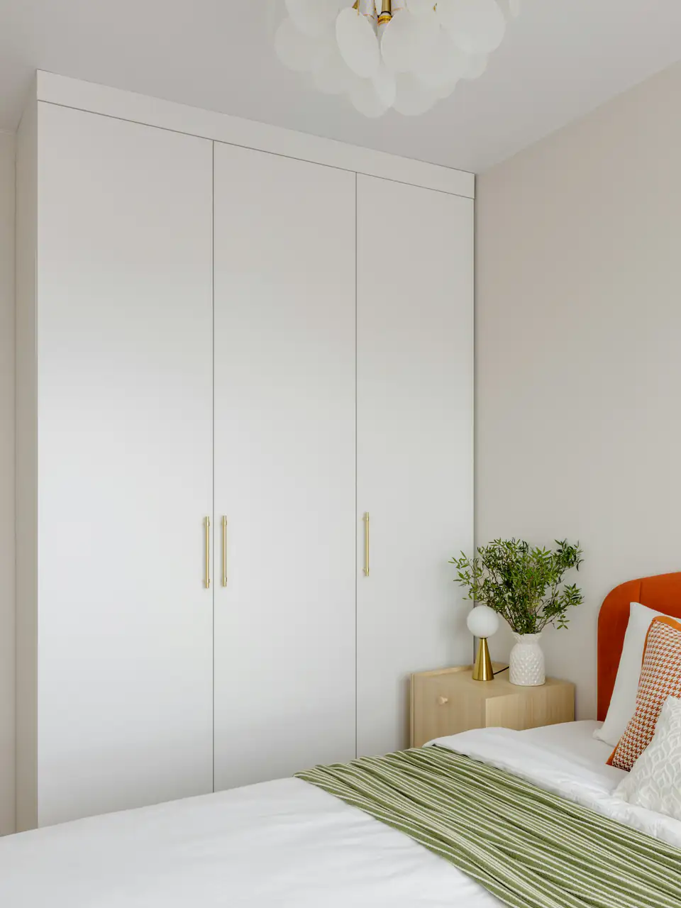 White floor-to-ceiling hinged wardrobe | Fitted wardrobes Newcastle White floor-to-ceiling hinged wardrobe doors with slim brass handles, a storage idea for homes in Newcastle
