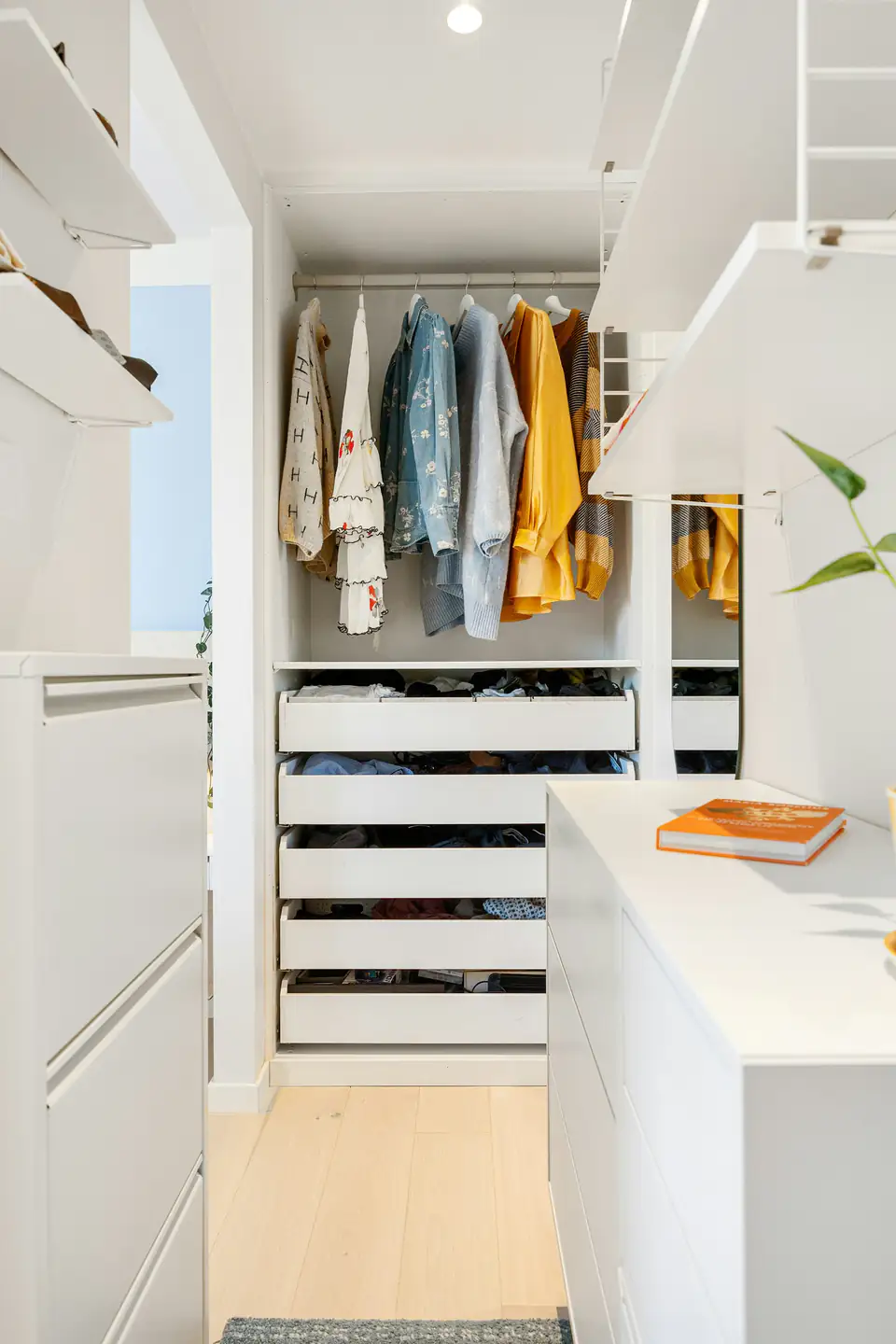 White wardrobe internal drawers | Fitted wardrobes Newcastle White wardrobe interior with internal drawers beneath hanging clothes, a storage idea for homes in Newcastle